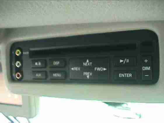 Overhead DVD player with RCA inputs and control buttons in gray headliner console