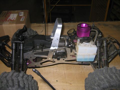 1994 Ford Bronco - Close-up view of the chassis and engine of a remote control car, a purple engine and a clear fuel tank.