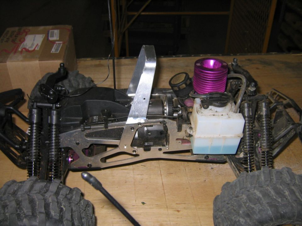 RC car chassis with purple engine and fuel tank