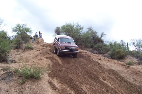 1992 Ford Bronco - This 1992 Ford Bronco navigates a steep, dusty incline in a desert landscape.