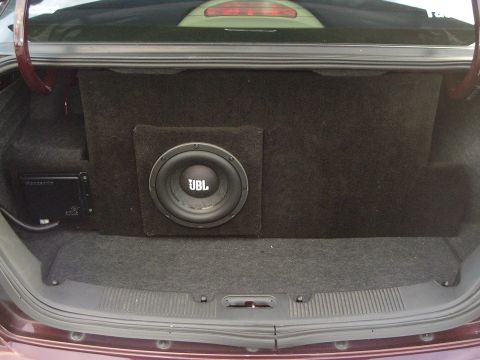 1993 Ford Taurus - Custom car audio setup in the trunk, a JBL subwoofer and amplifier.
