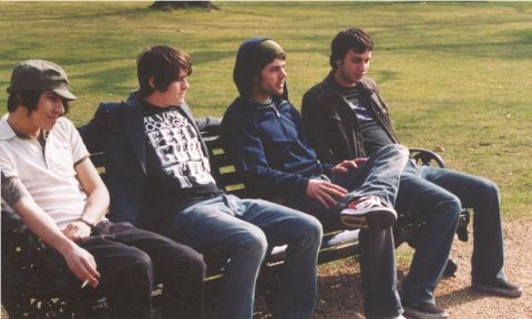 2000 Jeep Liberty - Four young men relax on a park bench outdoors on a sunny day.