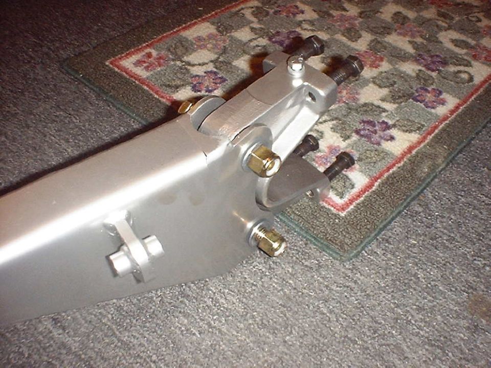 Axle-end clevis mounts and brass hardware on a silver fabricated radius arm