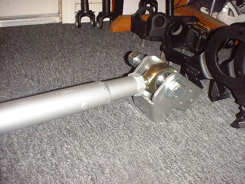 Threaded joint and zinc frame bracket on the end of a silver tubular radius arm
