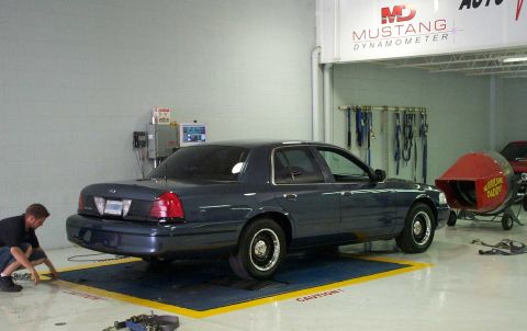 1998 Ford Crown Victoria - One of the techs begins to tie down the rear.