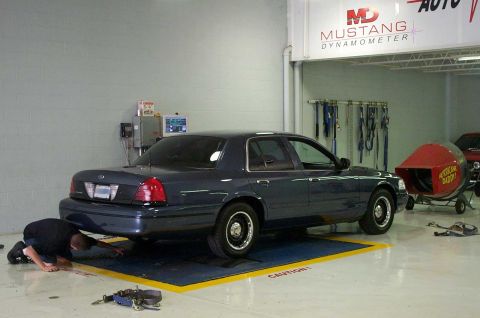 1998 Ford Crown Victoria - 1998 Ford Crown Victoria undergoing testing on a dynamometer in a workshop.