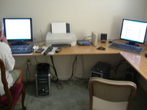 1996 Ford Taurus - A cluttered office desk setup with multiple computers and peripherals is visible.