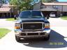 2000 Ford Excursion - A black Ford Excursion is shown from the front, parked outside a residential building.