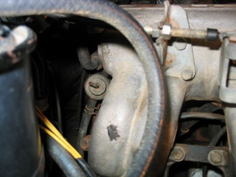 1986 Ford F-150 - Close-up view of engine components, including hoses and part of the intake manifold.