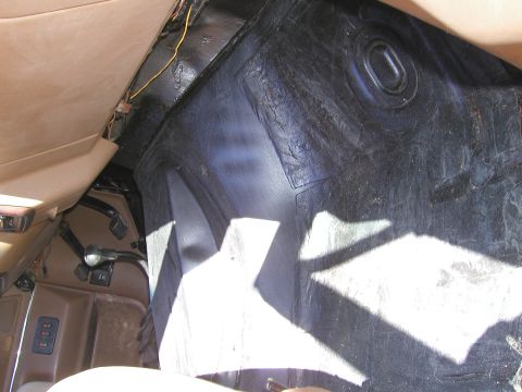 1989 Ford Bronco - The textured black floor mat is visible in the interior of the vehicle, with some wiring also apparent.