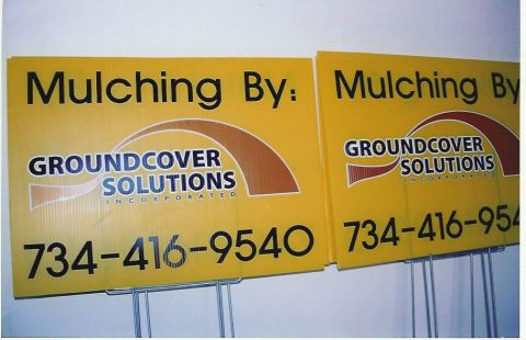1999 Jeep Grand Cherokee - Signs for a mulching service are displayed, showing the company name and contact number.