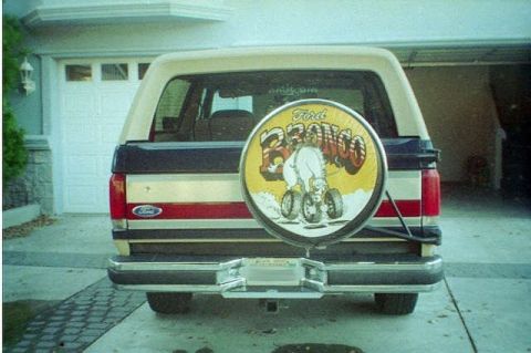 1991 Ford Bronco - This Ford Bronco has a custom spare tire cover with a cartoon horse and the words 'Ford Bronco'.