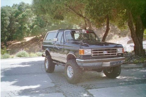 1991 Ford Bronco - This lifted Ford Bronco from the early 1990s is shown from a three-quarter front view.