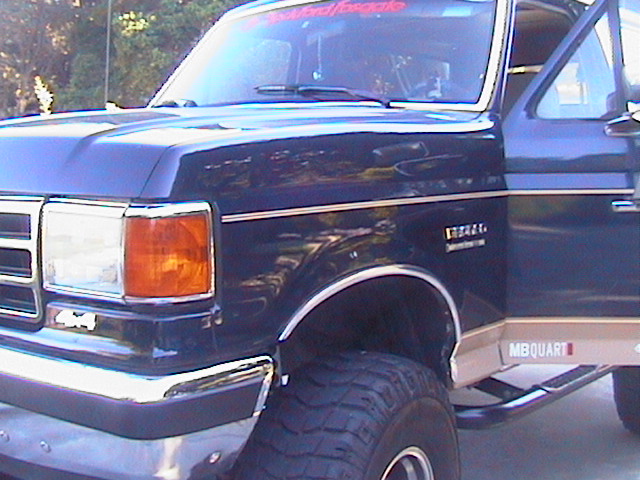 1991 Ford Bronco front fender and door with chrome trim and large tires