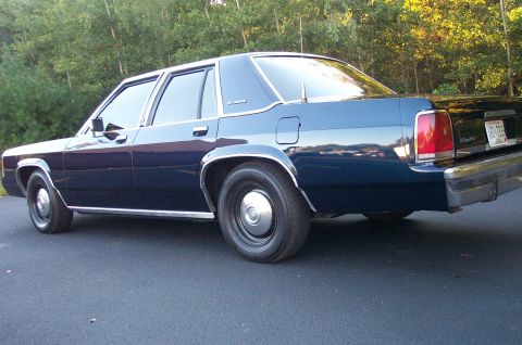 1991 Ford LTD Crown Victoria - Rear quarter view of a 1991 Ford Crown Victoria LTD sedan parked outdoors.