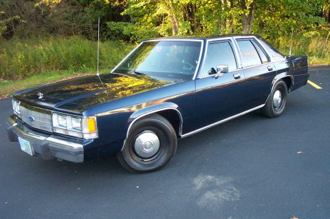 1991 Ford LTD Crown Victoria - This 1991 Ford Crown Victoria LTD sedan is shown in a 3q front view, parked outdoors.