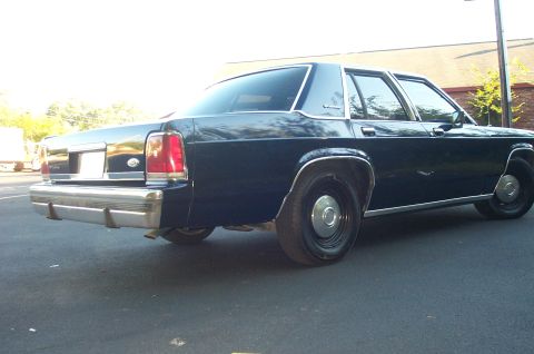 1991 Ford LTD Crown Victoria - Rear 3/4 view of a dark blue 1991 Ford Crown Victoria LTD sedan.