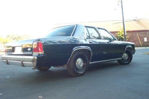 1991 Ford LTD Crown Victoria - Rear 3/4 view of a 1991 Ford Crown Victoria LTD sedan parked outdoors.