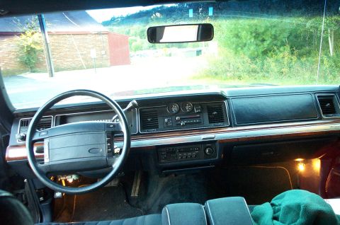 1991 Ford LTD Crown Victoria - The dashboard of a 1991 Ford Crown Victoria LTD, wood trim and a cassette player.