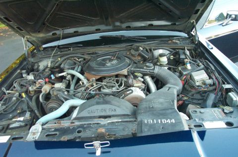1991 Ford LTD Crown Victoria - Close-up view of the engine bay, showing various components and some stamped numbers.
