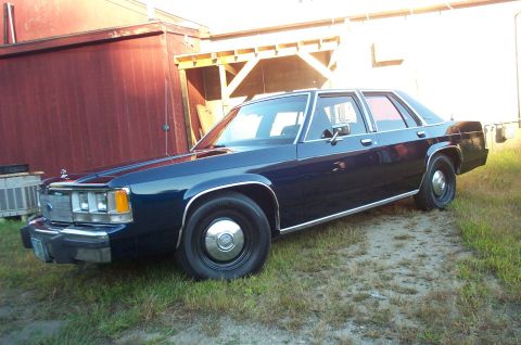 1991 Ford LTD Crown Victoria - This 1991 Ford Crown Victoria LTD sedan is seen from a 3q front angle, parked outdoors.