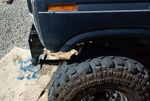 1986 Ford Bronco - Close-up of a 1986 Ford Bronco's front fender and aggressive off-road tire.