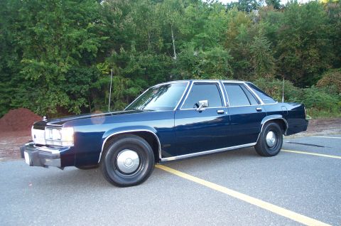 1991 Ford LTD Crown Victoria - This sedan has a boxy body style with chrome accents and steel wheels.