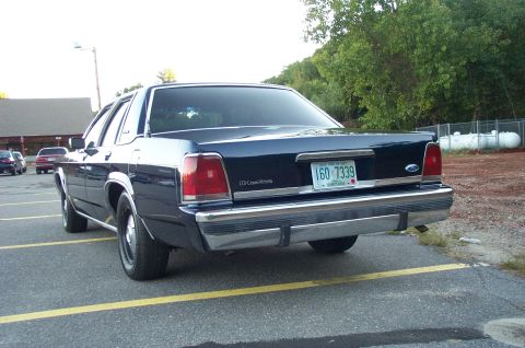 1991 Ford LTD Crown Victoria - Rear view of a dark blue 1991 Ford Crown Victoria LTD sedan parked in a lot.