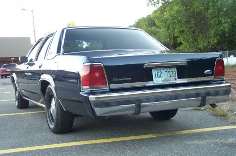 1991 Ford LTD Crown Victoria - Rear view of a 1991 Ford Crown Victoria LTD parked in a lot. Another car is visible in the background.