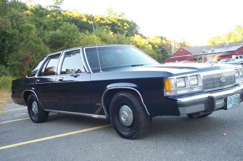 1991 Ford LTD Crown Victoria - This sedan has a boxy body style and chrome trim, typical of cars from the early 1980s.
