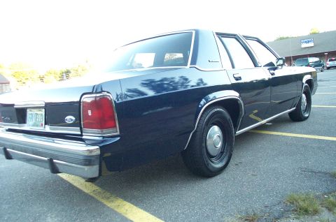 1991 Ford LTD Crown Victoria - Rear view of a 1991 Ford Crown Victoria LTD sedan parked in a lot.