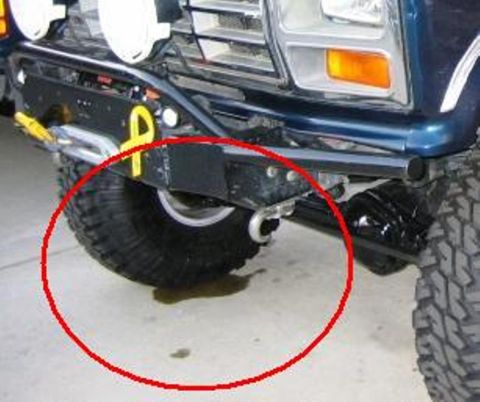 1985 Ford Bronco - This 1980s Ford Bronco shows a fluid leak under its front tire.