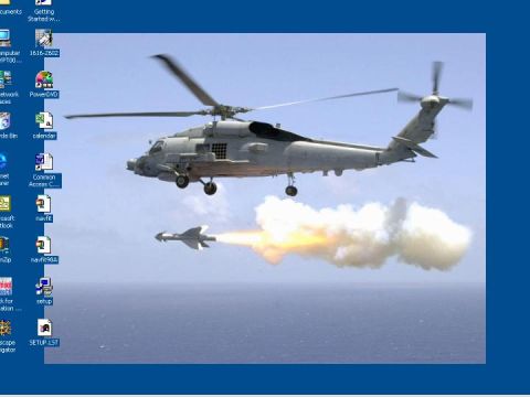 1993 Ford Bronco - A military helicopter launches a missile during a training exercise over the sea.