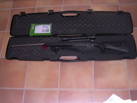 1985 Ford Bronco - A rifle with a scope is displayed inside its protective case.