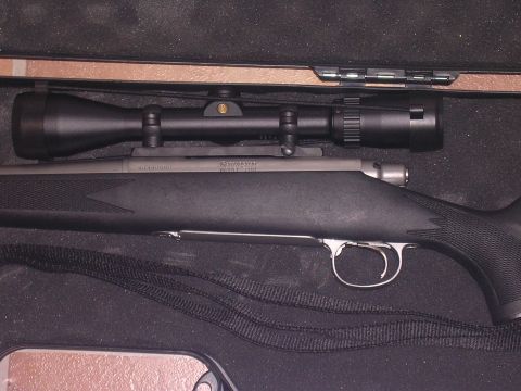1985 Ford Bronco - A rifle with a scope is shown inside its protective case.