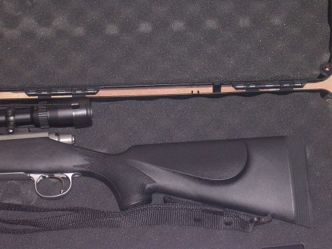 1985 Ford Bronco - A rifle with a scope is stored in a protective case with custom foam cutouts.