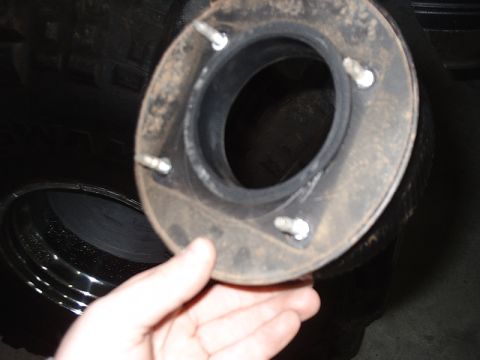 1996 Ford Bronco - Close-up of a rubber seal with mounting hardware, possibly from a vehicle component.