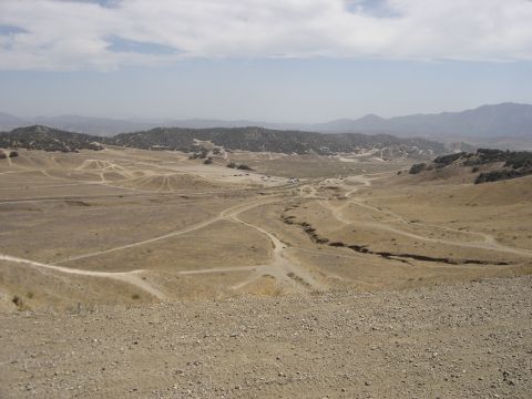 1988 Ford Bronco - A wide view of an off-road park with multiple vehicles traversing the terrain.