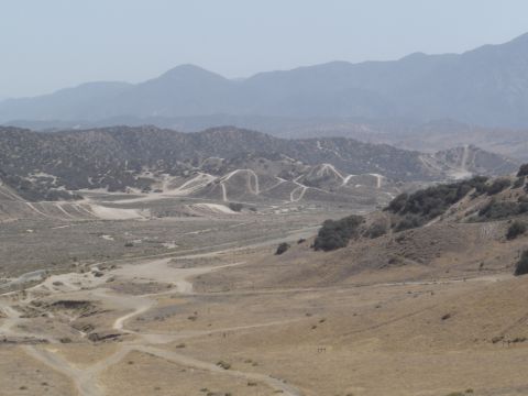 1988 Ford Bronco - View of a vast, arid terrain with rolling hills and distant mountains under a hazy sky.