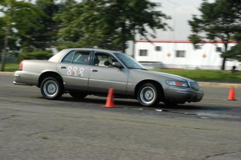 2001 Mercury Grand Marquis - 2001 Mercury Grand Marquis seen participating in a driving event with numbered decals on its side.