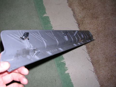 2003 Chevrolet Monte Carlo - Close-up of a gray interior trim piece with mounting clips, likely a car part.