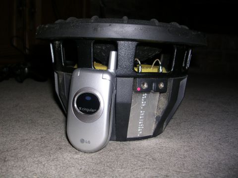 2003 Chevrolet Monte Carlo - A U.S. Audio subwoofer is shown next to an LG flip phone.