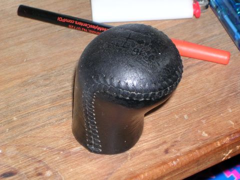 2003 Chevrolet Monte Carlo - Close-up of a leather shift knob, likely for a manual transmission, on a workbench.