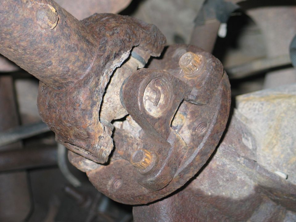 Remove the 4 bolts from the rear axle using a 12mm or 1/2" 12 point socket or wrench.