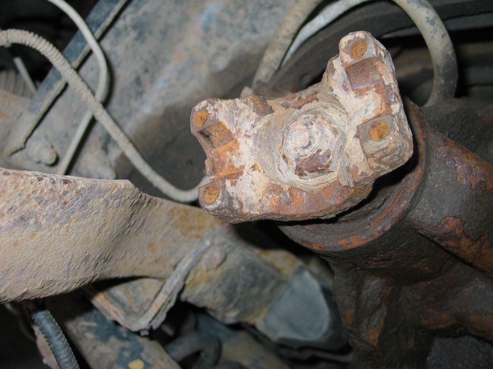 Remove the front driveshaft.Take the 4 nuts off the t-case yoke and the 4-nuts of the yoke on the front axle side of the front driveshaft. You will probably need a 1/2" wrench. Don't plan on re-using the u-bolts...so go ahead and try and beet them out. Once the nuts are off, use a prybar to pry the driveshaft free from the yokes.
