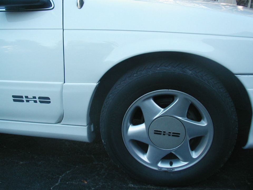 White Ford Taurus SHO front wheel with SHO center cap and rocker badge