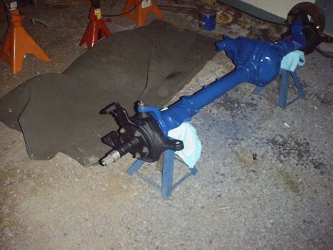 1988 Ford Bronco - A freshly painted front axle assembly rests on jack stands, ready for reinstallation.