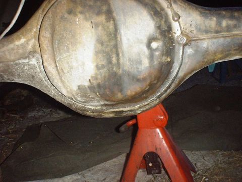 1988 Ford Bronco - Rear axle differential housing on an orange jack stand, likely undergoing maintenance.