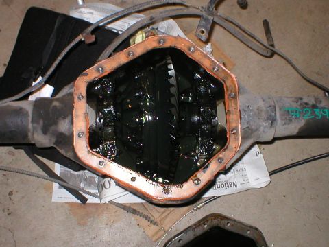 1978 Ford Bronco - Close-up of a vehicle's differential housing, revealing internal gears and lubricant.