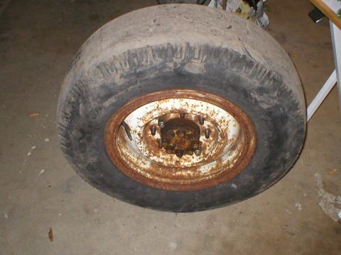 1978 Ford Bronco - This is a close-up of an old tire and a rusty wheel, likely a spare or replacement part.